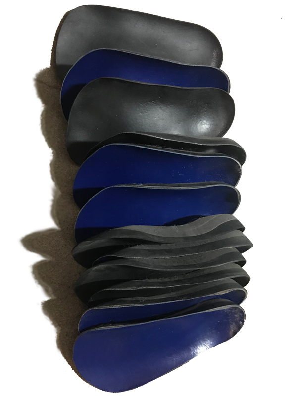 Stack of custom made foot orthotics by Elite Feet USA