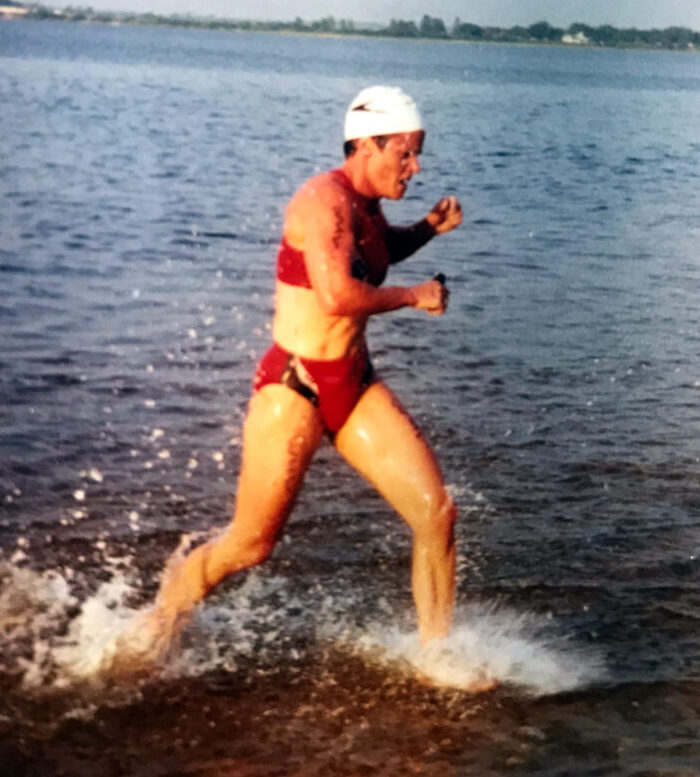 11-Time Ironman Triathlete Tammy Harbison transitioning from the swim to her bike